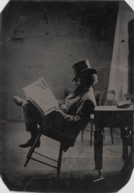 victorian man reading newspaper by the fire